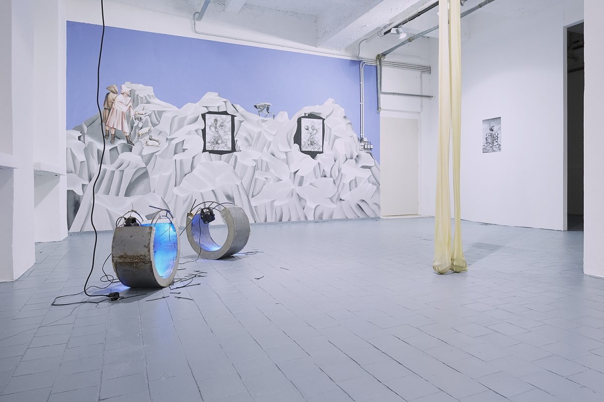 Installation view of the exhibition, ‘Extra-Planetary Commitment’, lítost gallery, Prague. From left to right: Evita Vasiljeva, ‘Hormones’, (2017), metal, concrete, wood, cable ties, noise sensitive light, wires, each part 25 cm x 57 cm x 57 cm – Courtesy of the artist gallery; Botond Keresztesi, “Miss Universe 1”, black colour airbrush on paper, 29.7 cm x 42 cm – Courtesy of the artist; Botond Keresztesi, “Miss Universe 2”, black colour airbrush on paper, 29.7 cm x 42 cm – Courtesy of the artist; Evita Vasiljeva – ‘There is no Grace in Shrinking’, (2017), latex, pump, plastic tubes, various sizes – Courtesy of the artist; And Botond Keresztesi, “The Audience”, black colour airbrush on paper, 29.7 cm x 42 cm – Courtesy of the artist. Photograph by Lenka Glisníková. © lítost